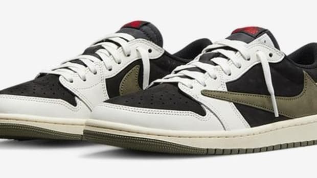 Side view of white, black, and green Jordan sneakers.